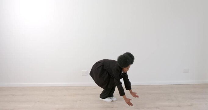 High speed photography for dynamic scenes, Bending forward, person in black coat stretching arms tow