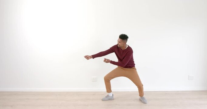 Man dancing energetically in living room, expressing creativity and joy