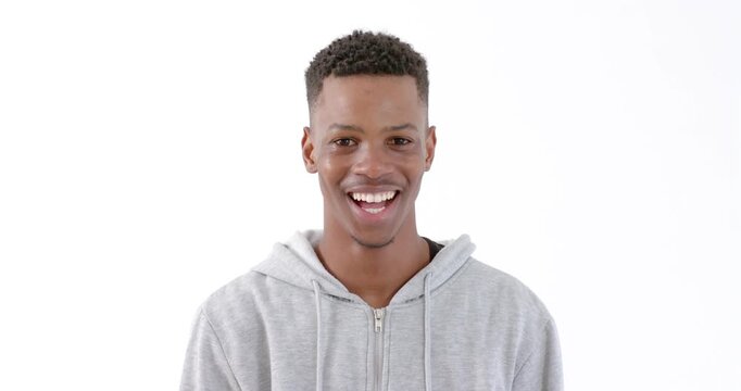 African American man laughing joyfully in casual hoodie against white background