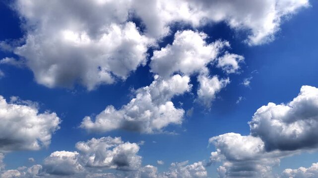 White cumulus clouds floating in the blue sky
