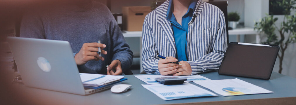 Business professional analyzing financial data on digital tablet dashboard with calculator and laptop, representing accounting software, ERP system integration, performance monitoring.