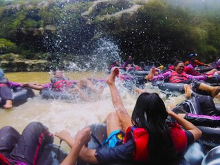 Enjoying River Tubing Adventure and Water Splashing Action © Matchlessia