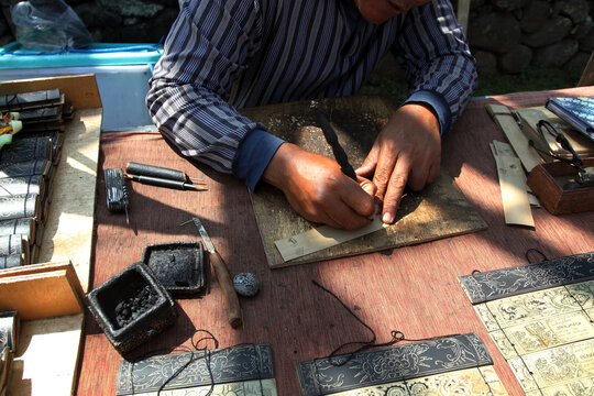 Balinese painting and writing on lontar leaves (Borassus flabellifer) known as "Prasi". Scratched with special knife called "Pangrupak" and smeared with burnt candlenut charcoal.