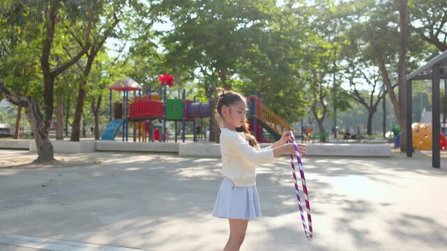 Young Thai Girl Playing with Hula Hoop at Lumpini Park Playground