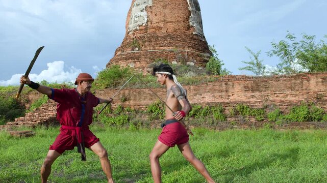 Thai Warriors Sparring with Swords at Ancient Ayutthaya Temple Ruins