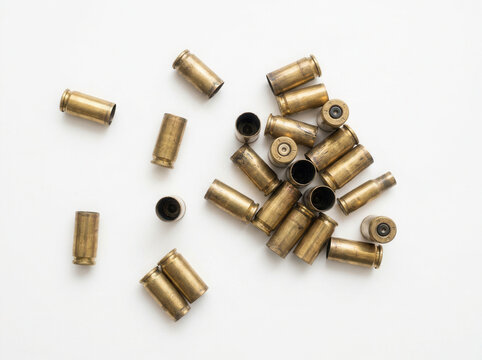 Spent Brass Ammunition Casings Scattered on White Background