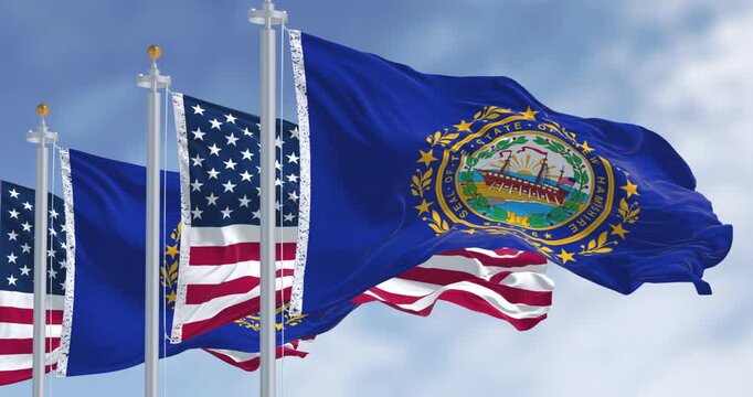 New Hampshire and National US flags waving in the wind on a clear day