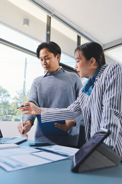 Business professional analyzing financial data on digital tablet dashboard with calculator and laptop, representing accounting software, ERP system integration, performance monitoring.