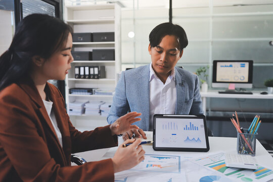 Business professional analyzing financial data on digital tablet dashboard with calculator and laptop, representing accounting software, ERP system integration, performance monitoring.