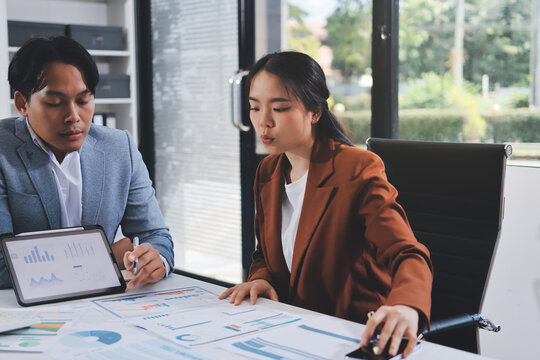 Business professional analyzing financial data on digital tablet dashboard with calculator and laptop, representing accounting software, ERP system integration, performance monitoring.