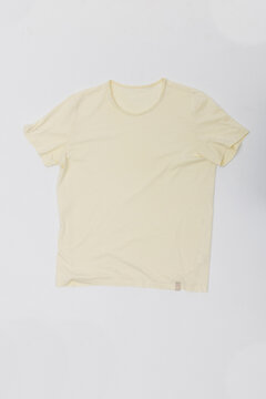 Plain cream short sleeve t-shirt isolated on white studio background. Front view product shot of basic beige cotton tee, ideal for clothing mockup, apparel design and e-commerce template.