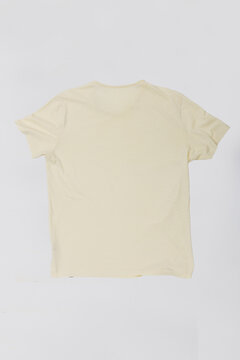 Plain cream short sleeve t-shirt isolated on white studio background. Back view product shot of basic beige cotton tee, ideal for clothing mockup, apparel design and e-commerce template.