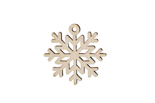 Wooden snowflake ornament isolated on transparent background, natural handcrafted Christmas decoration with intricate symmetrical design, winter holiday symbol for festive decor and seasonal projects