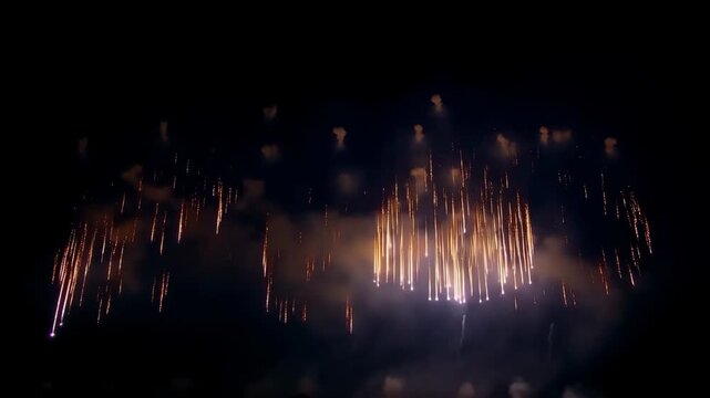 Firework Display Illuminating Smoky Night Sky with Golden Pink Celebration Bursts and Glowing Smoke
