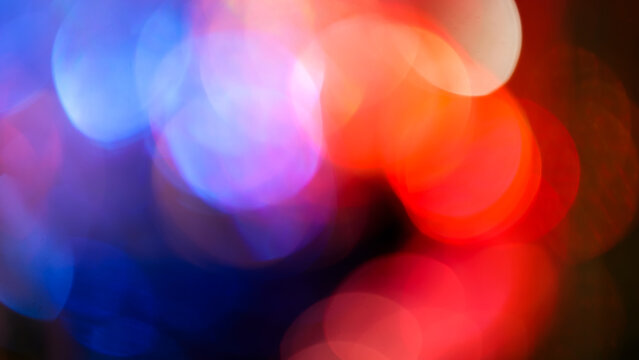 Abstract blurred bokeh background with soft red and blue circles and white highlights