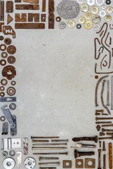 A frame of various old rusty bits and pieces arranged on a concrete surface © Taigi
