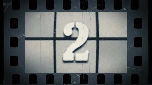 Old film strip countdown from 5 to 0 in grey color. Vintage defocused film look, flicker, grain, and scratches effect