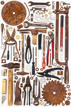 Flat lay of old hand tools on white background.