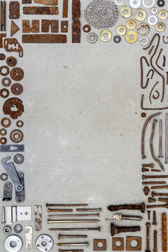 A frame of various old rusty bits and pieces arranged on a concrete surface