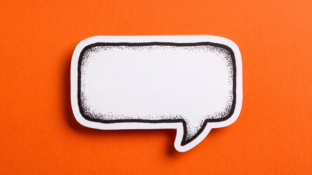 Empty speech bubble cutout with hand drawn ink texture on a vibrant orange background creates a simple minimalist design element
