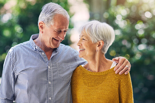 Senior, couple and smile with hug at park for weekend outing, marriage loyalty or bonding together. Talk, people and happy with embrace in nature for retirement date, relationship connection and love