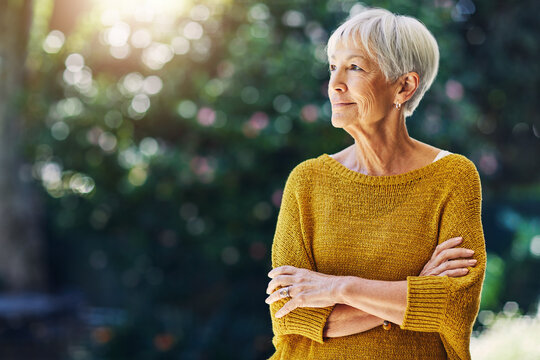 Garden, thinking and senior woman with morning for reflection, nostalgia and daydreaming outdoor. Retirement, weekend and old person in nature with bokeh for space, memory and relax with arms crossed