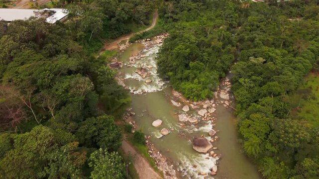 Breathtaking aerial footage flying away from the tena river revealing the amazonian town of tena, ecuador