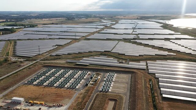 Aerial drone view of Cleve Hill Solar Park near Faversham, Kent, showing large-scale renewable electricity generation, battery storage and modern solar infrastructure.