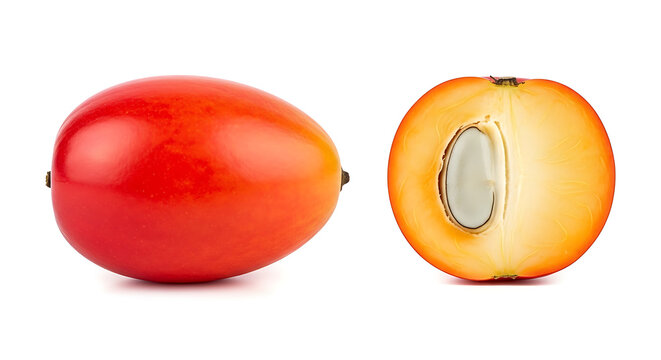 Whole and halved fresh red palm oil fruit isolated on a white background