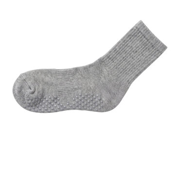 A gray ribbed sock with textured grip dots rests on transparent background footwear garment clothing
