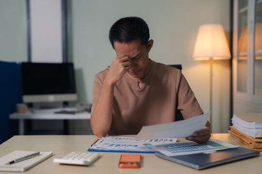 stressed asian businessman working in the office. Businessman thinking too much work concept in the office.