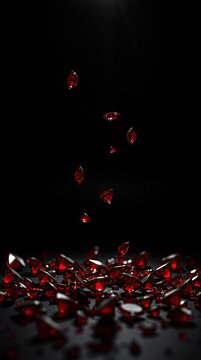 Red gems drop from above and scatter onto a pile of red gems on a dark surface. The setting highlights the shiny textures and rich colors of the gems