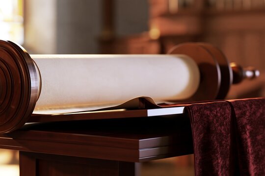 Torah scroll resting on a table in warm synagogue light, Jewish religious concept for Shemini Atzeret, Simchat Torah, Torah reading, holiday articles and greeting designs