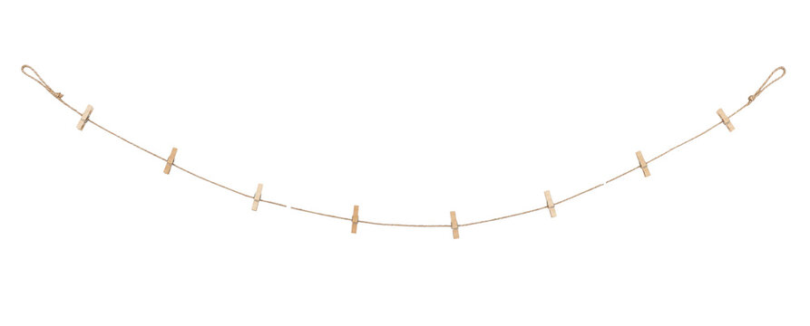 Simple brown jute rope with small wooden clothespins hanging in a gentle curve against a clean white background