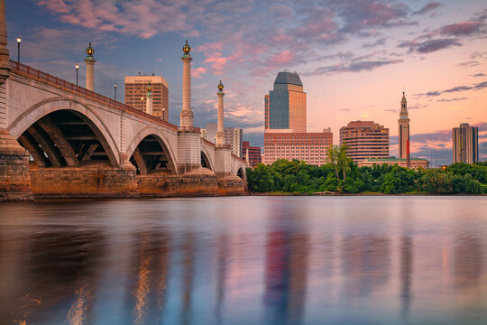 Springfield, Massachusetts, USA. Cityscape image of Springfield, Massachusetts with reflection of the city skyline in the water at beautiful summer sunset.