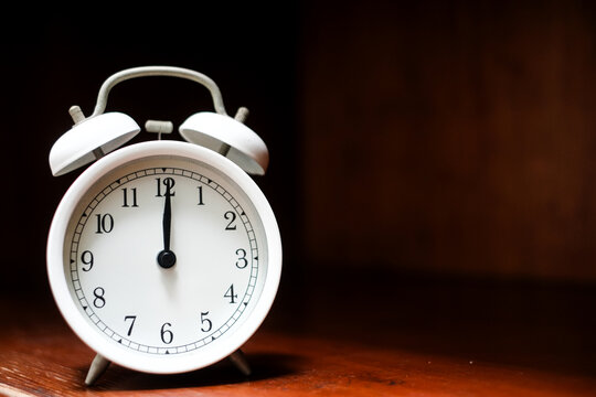 Classic alarm clock on dark background