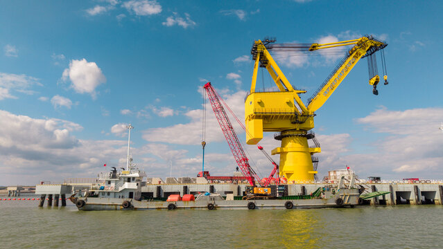 Floating Cranes and Work Vessel at Port Waterfront