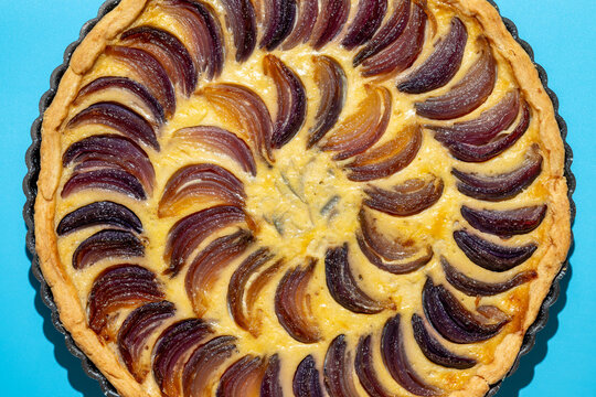 Close-up of a spiral-pattern onion tart
