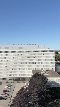 Helsinki, Hakaneiemi, Toinen Linja Tilt From a Rooftop Edge Up to Clear Blue Sky Vertical