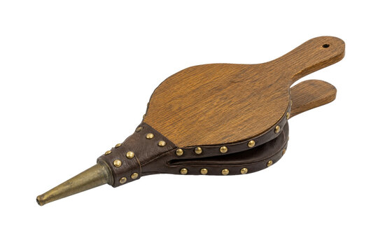 Vintage wooden and leather fireplace bellows with brass nozzle and studs is angled on a white background