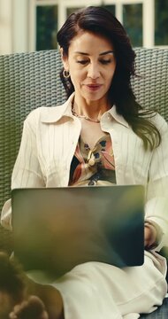 Laptop, vacation or woman on lounger to relax, luxury travel or typing blog as digital nomad. Computer, holiday and mature person with article for hotel critic, freelance review or reading story