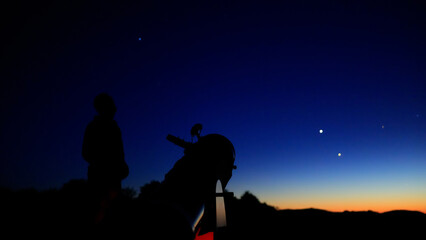 Amateur astronomer observing stars, planets, Moon and other celestial objects with a telescope in nature. © astrosystem