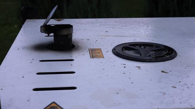 Close-up of a heavy industrial generator or power equipment metal panel with safety hazard warning signs