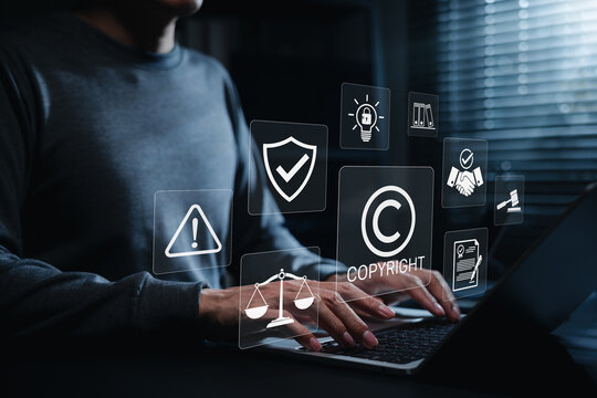 Copyright protection concept. Person using laptop with copyright, legal, security, and compliance icons, representing intellectual property rights, digital content protection and online law management