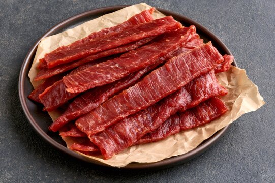 Beef jerky strips on plate with craft paper