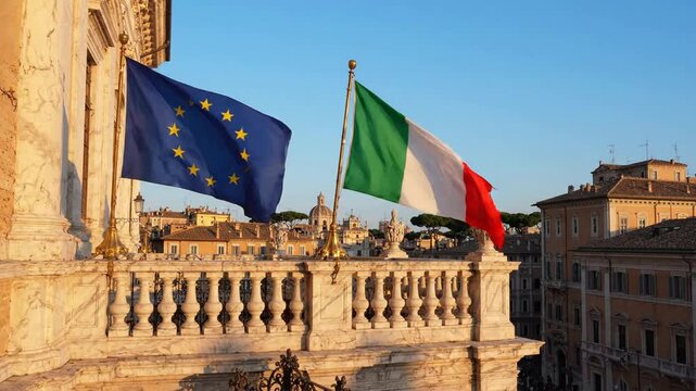European union and italian flags waving together over rome cityscape at sunset italy