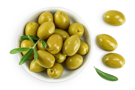 Green olives in ceramic bowl isolated on a white background. Top view. Flat lay