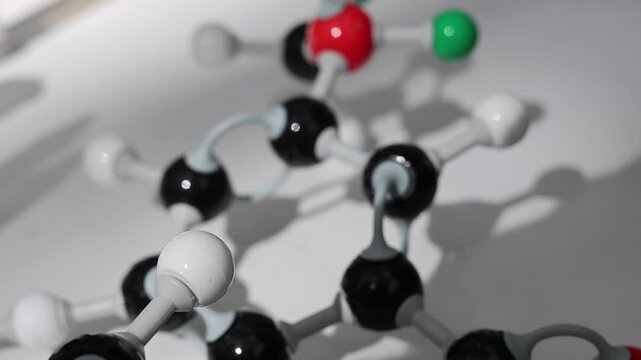 Biochemical drug discovery concept showing a molecular atomic structure model in a laboratory