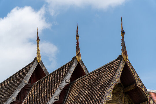 Ornate temple roof gable with carved finials, traditional Thai