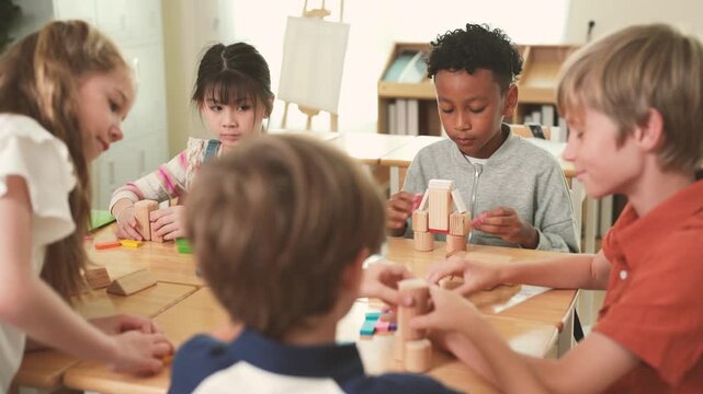 Diverse elementary students play with colorful wooden blocks together at classroom table, developing creativity, problem solving, teamwork, hands-on learning.